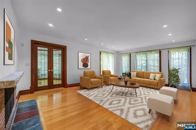 a living room with furniture rug and wooden floor