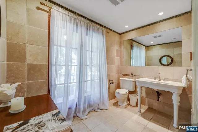 a bathroom with a double vanity sink toilet and shower
