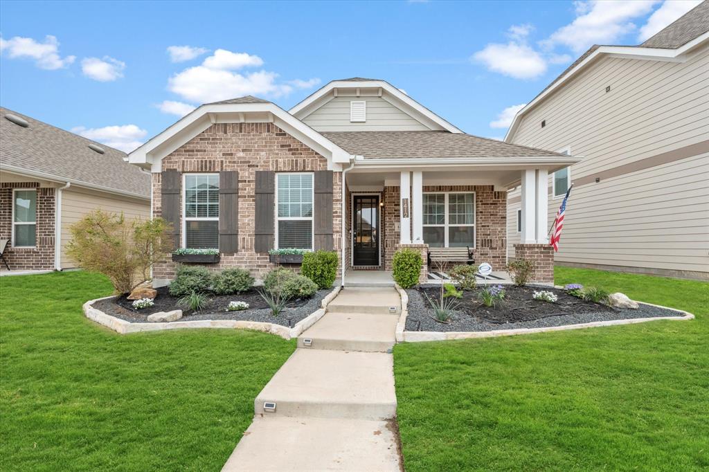 a front view of a house with a garden and plants