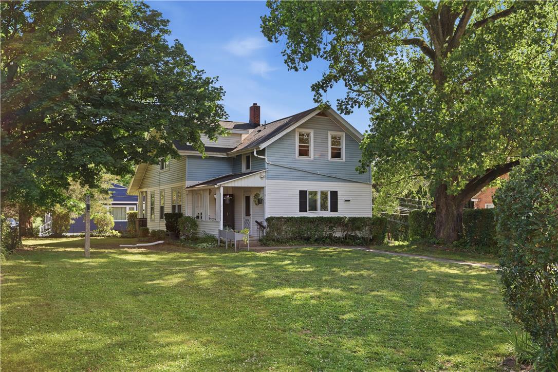 2021 Leithsville Road Hellertown, PA 18055 - Photo 33 of 39 A charming two-story residence with a welcoming front porch, nestled amidst mature trees and a verdant lawn.