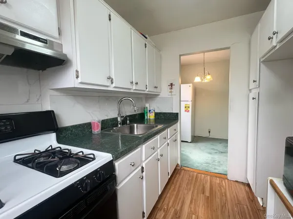 a kitchen with a sink stove and cabinets