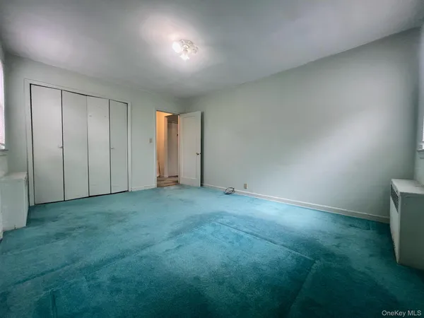 an empty room with an empty space and windows