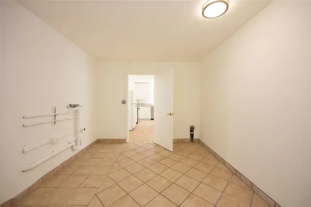 a living room with furniture and a book shelf
