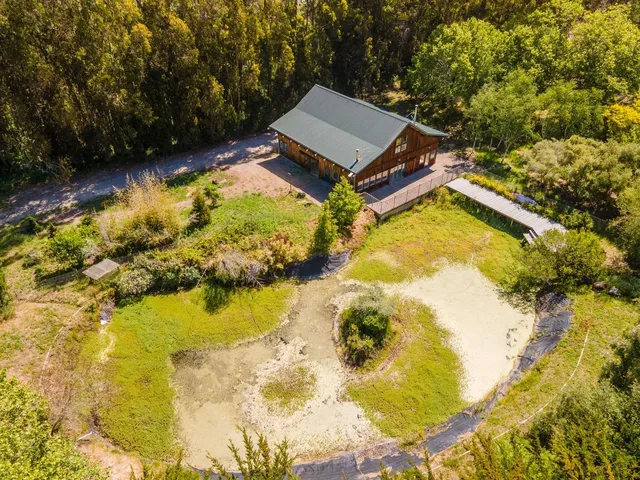 a swimming pool with trees in the background
