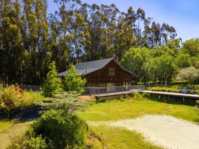a view of a house with swimming pool and sitting area