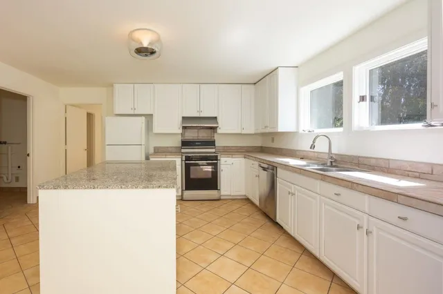 a kitchen with cabinets and white appliances