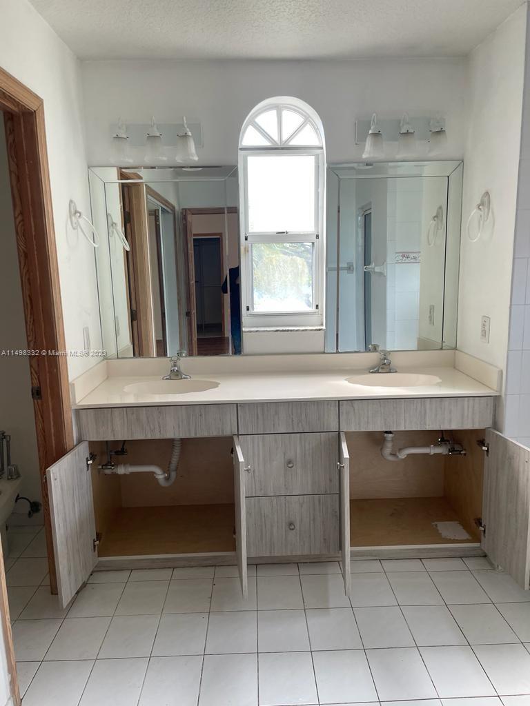 The Hammocks Miami, FL 33196 - Photo 6 of 8 a bathroom with a sink and a mirror