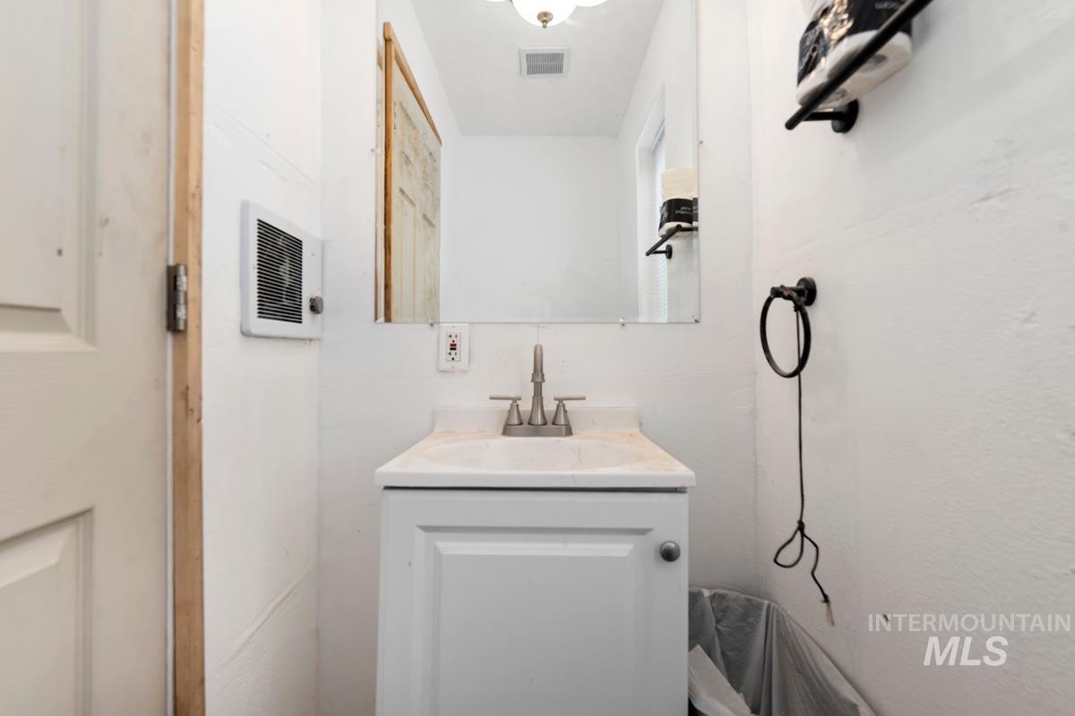 7 Scenic Rim Circle Lowman, ID 83637 - Photo 8 of 35 White vanity with an integrated sink and a chrome-finish faucet