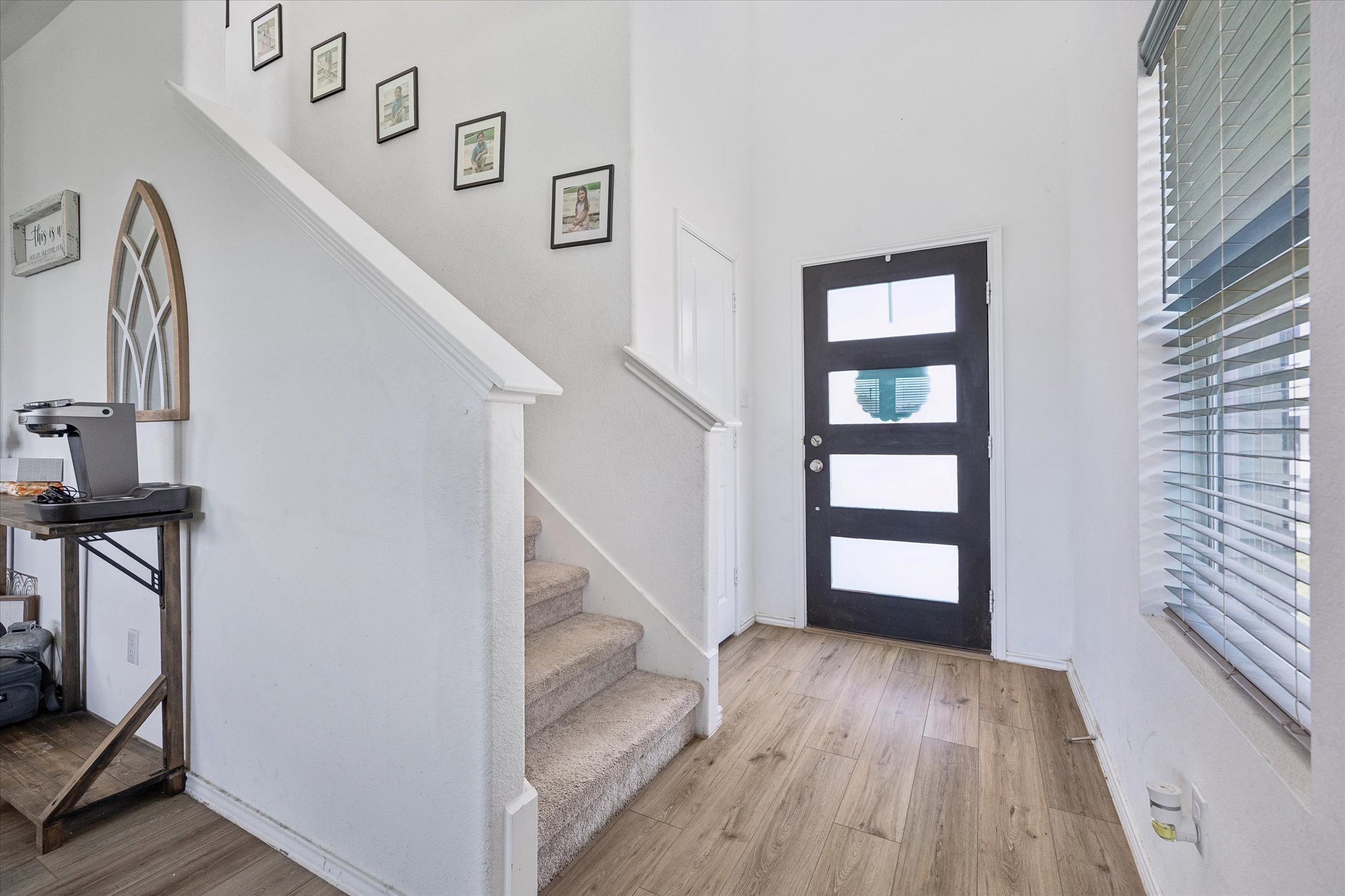 217 Canley Loop Hutto, TX 78634 - Photo 7 of 36 A welcoming entryway with sleek wood flooring and a modern paneled door.
