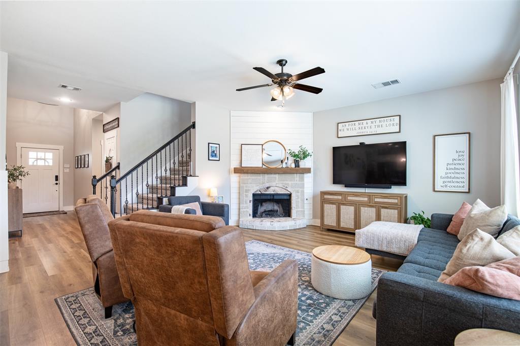 416 Allbright Road Celina, TX 75009 - Photo 6 of 40 a living room with furniture a fireplace and a flat screen tv
