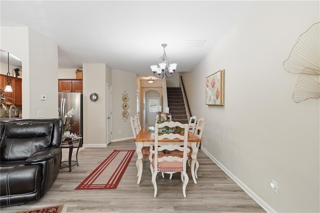 608 Myers Gate Road Ball Ground, GA 30107 - Photo 8 of 31 a view of a dining room with furniture and wooden floor