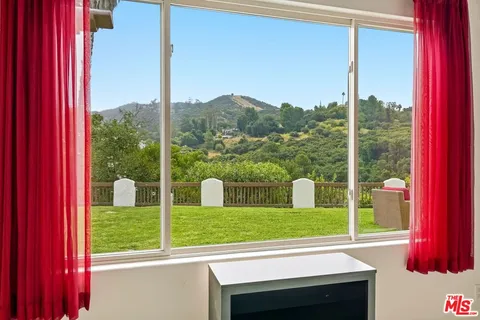 a view of a room with window and pool table