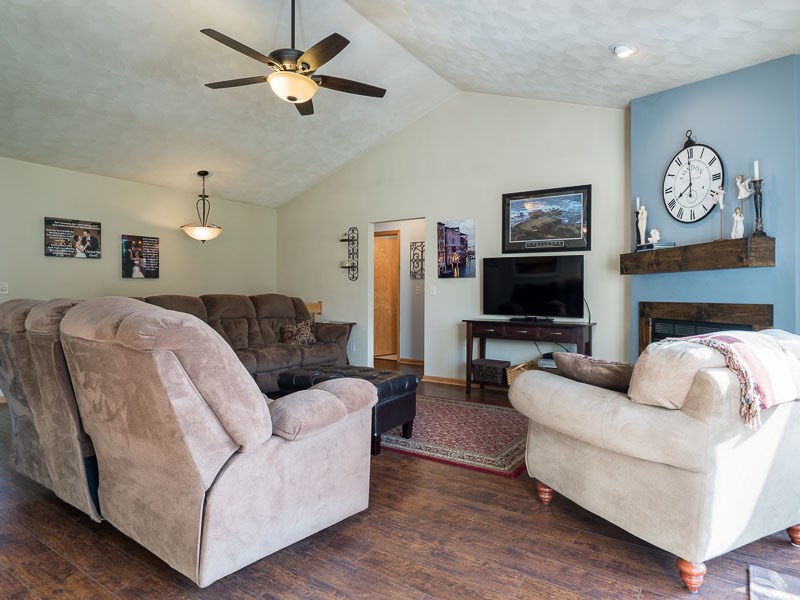 9683 Rambouillet Ridge Roscoe, IL 61073 - Photo 7 of 25 a living room with furniture a clock and a flat screen tv