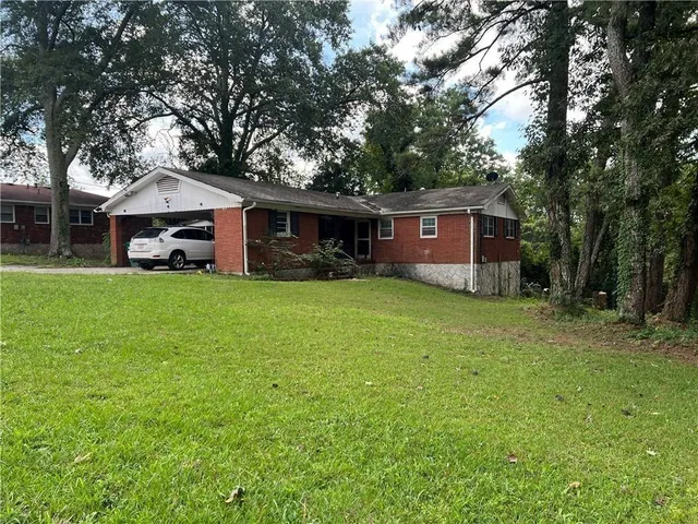 a front view of house with yard and green space