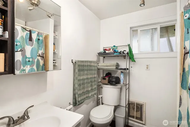 a white toilet sitting next to a bathroom sink