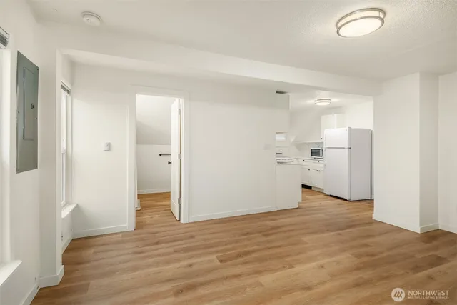 a view of a kitchen with a refrigerator a sink and a stove top oven