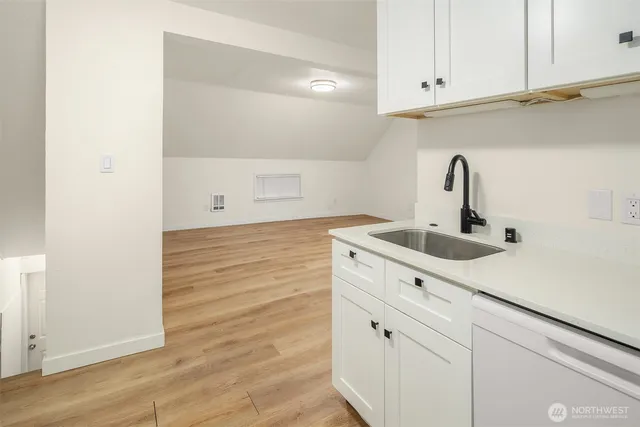 a kitchen with a sink and cabinets