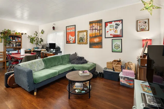 a living room with furniture a rug and a flat screen tv