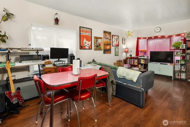a living room with furniture a flat screen tv and a dining table