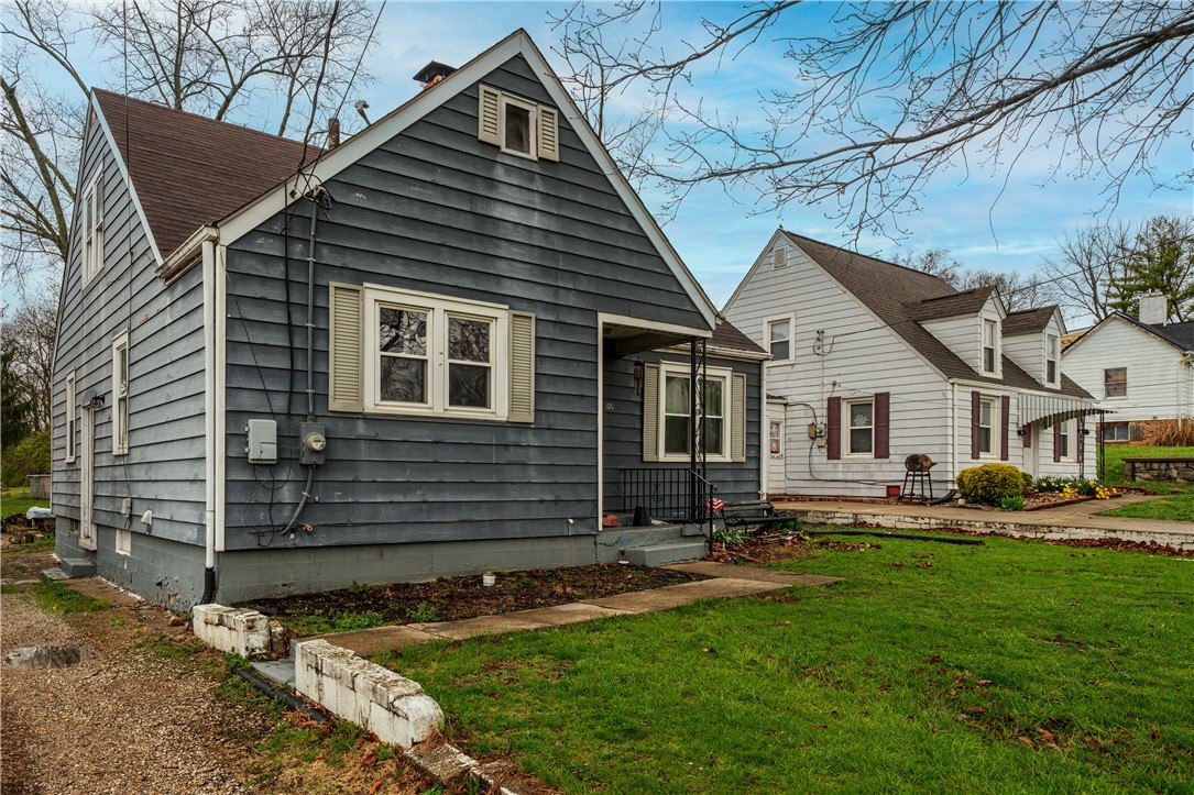106 Burton Road Middletown, OH 45044 - Photo 2 of 7 This charming home offers classic appeal with a welcoming facade and lush green yard.
