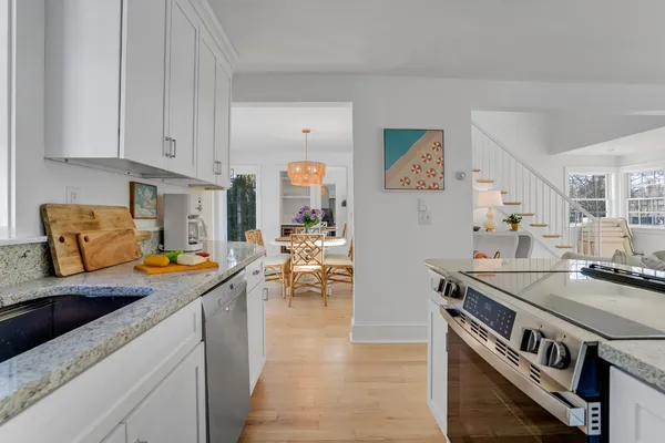 a kitchen with stainless steel appliances granite countertop a stove a sink and a refrigerator