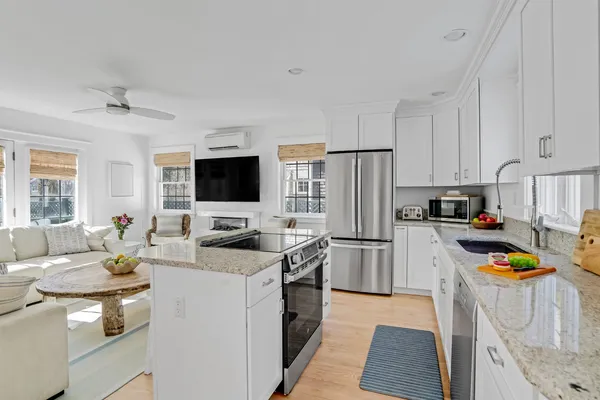 a kitchen with stainless steel appliances a stove refrigerator sink and microwave