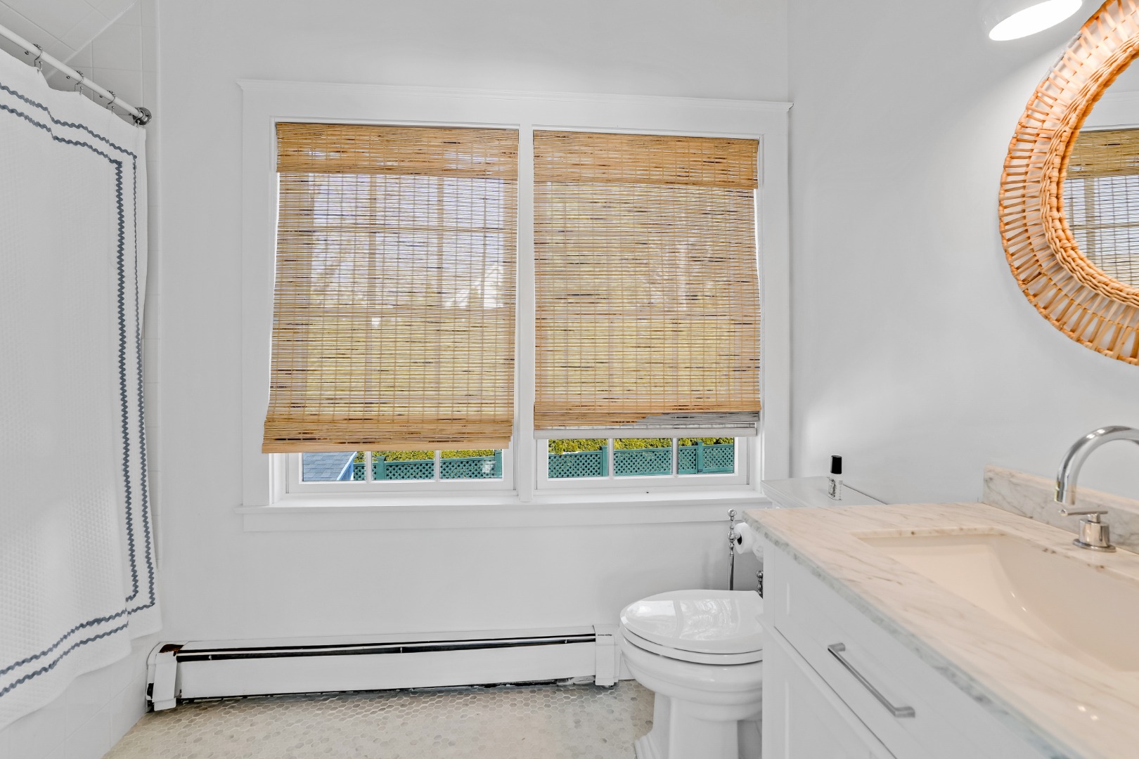 99 Cooke Street Edgartown, MA 02539 - Photo 18 of 26 a bathroom with a granite countertop toilet a sink and a window