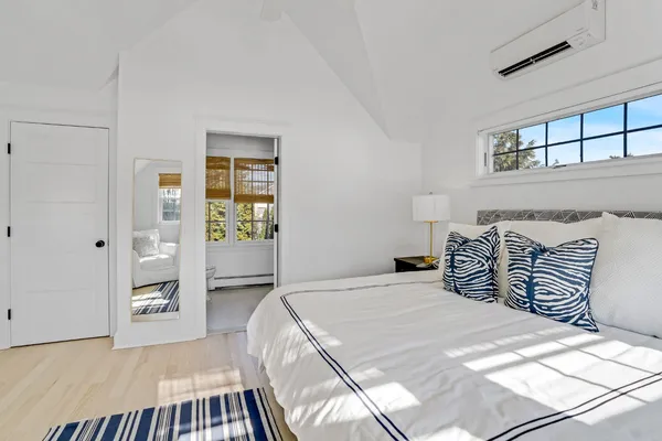 a bedroom with a large bed and a chandelier