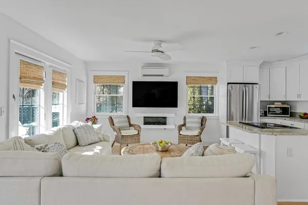 a living room with fireplace furniture and a flat screen tv