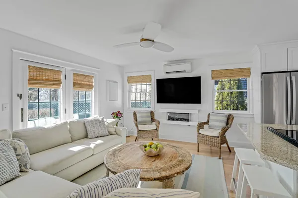 a living room with furniture floor and a flat screen tv