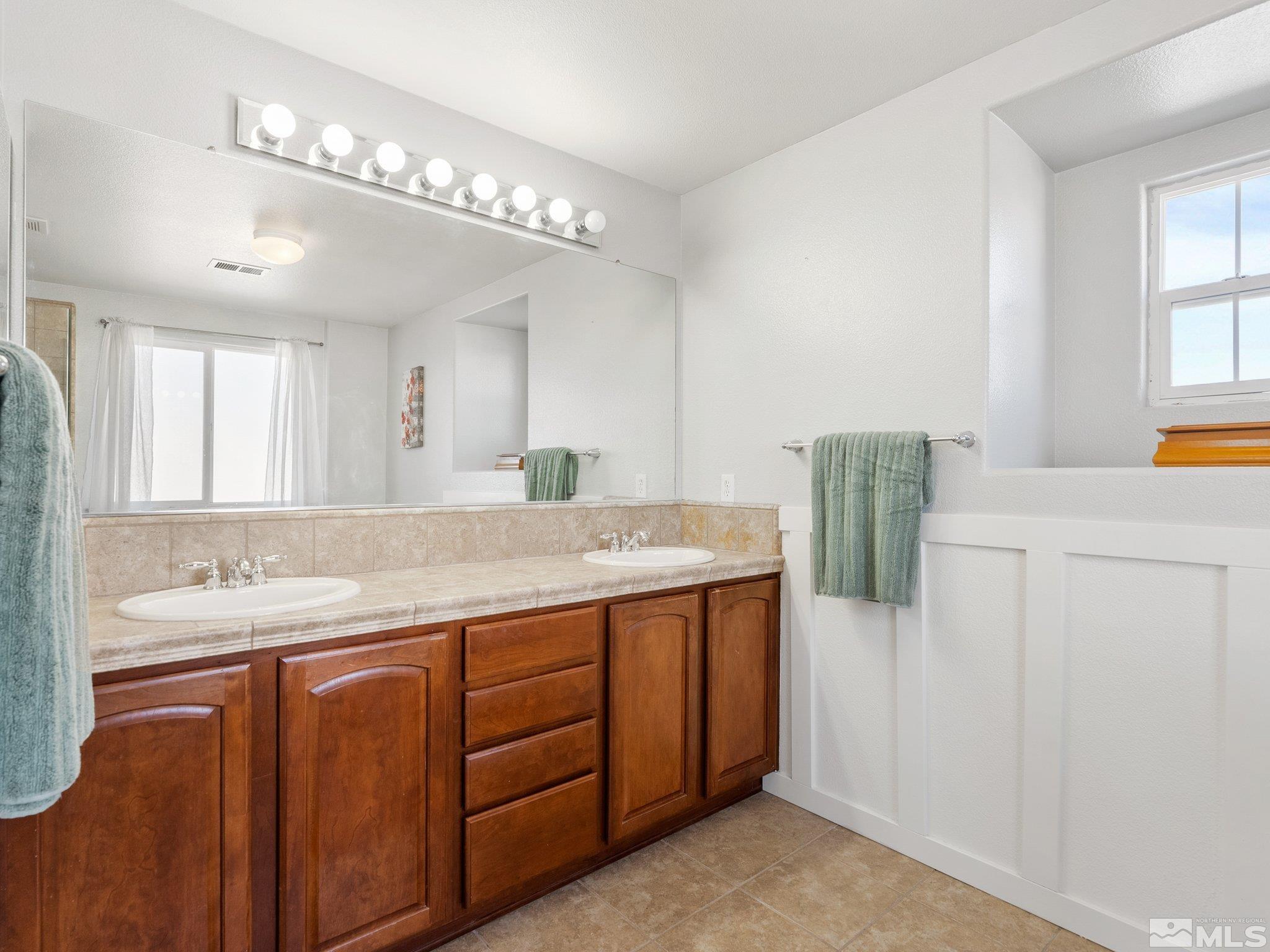 3451 Weaver Place Reno, NV 89512 - Photo 25 of 40 a bathroom with a granite countertop sink and a mirror
