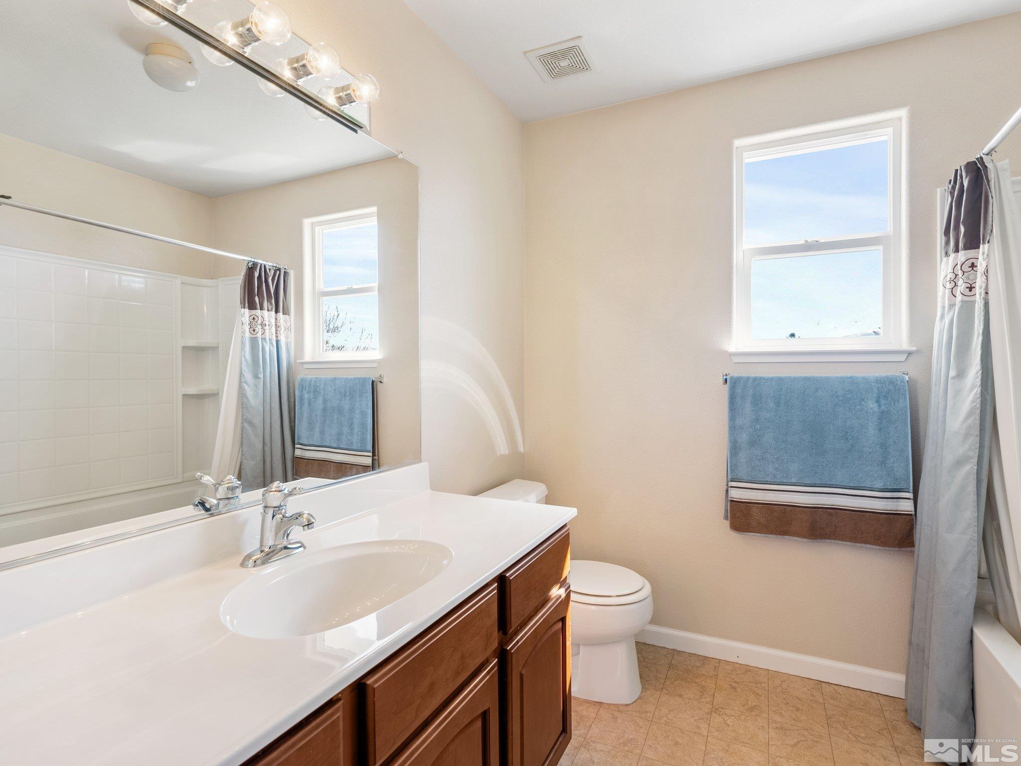 3451 Weaver Place Reno, NV 89512 - Photo 27 of 40 a bathroom with a sink a toilet and a mirror