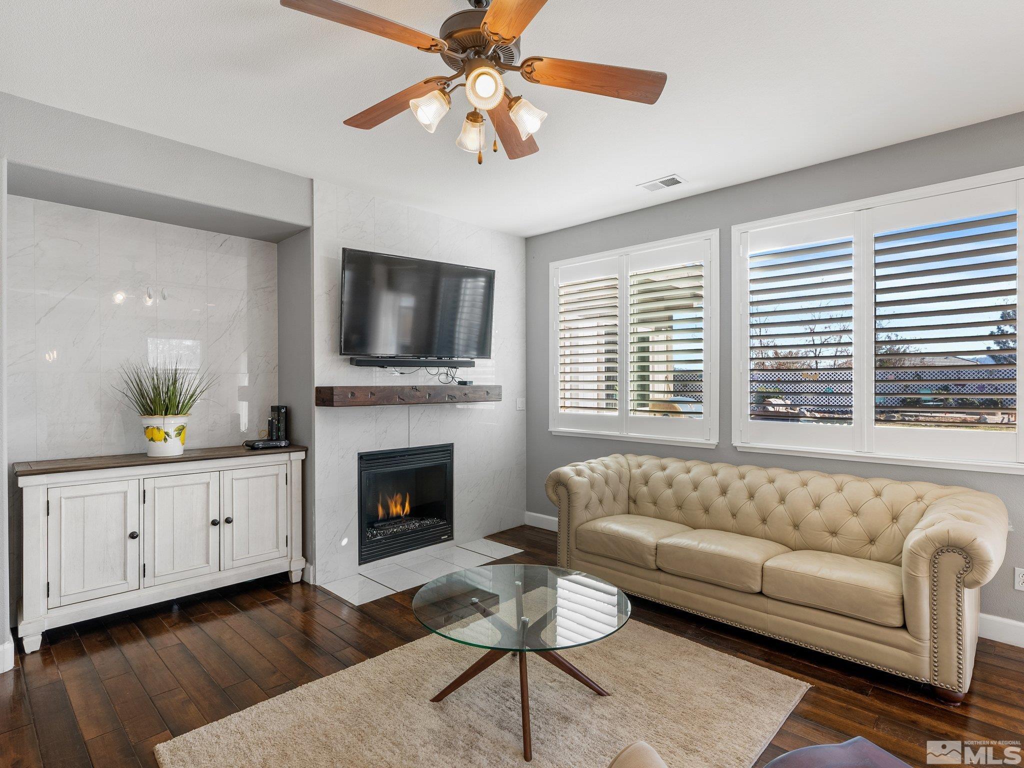 3451 Weaver Place Reno, NV 89512 - Photo 5 of 40 a living room with furniture fireplace and flat screen tv