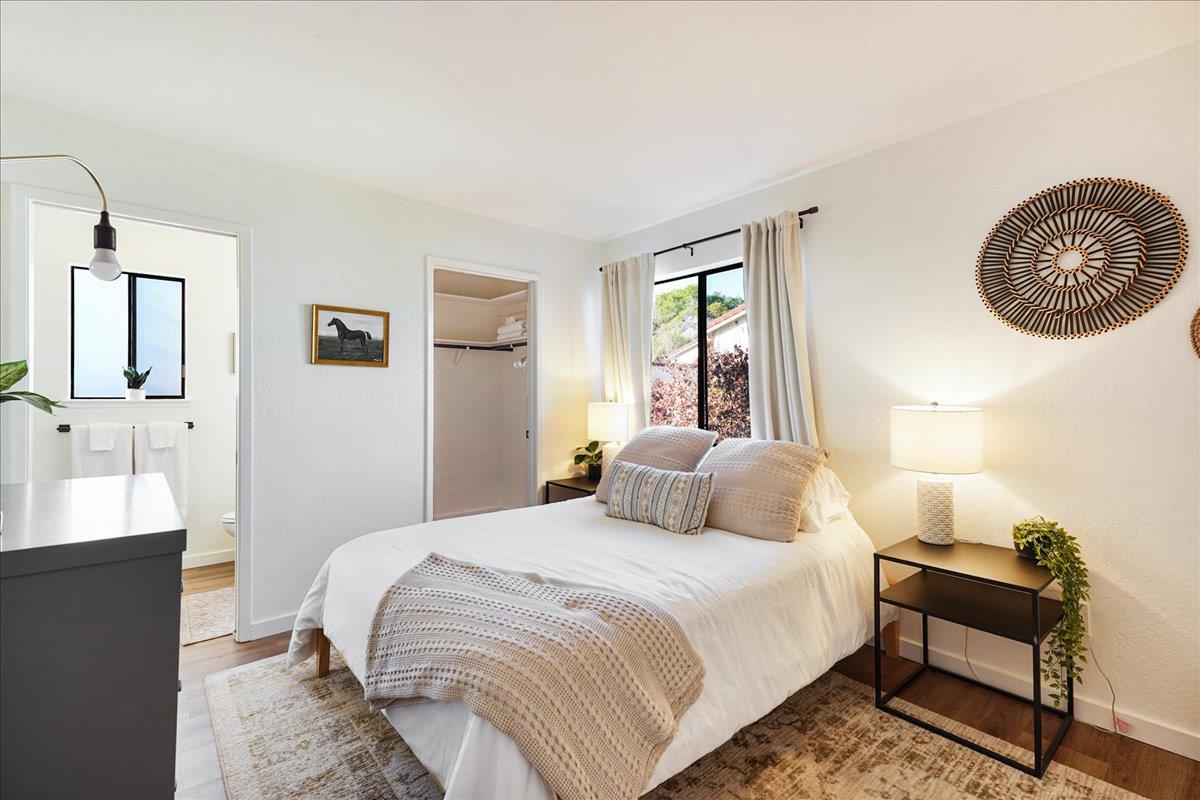 3003 Corte Cabrillo Aptos, CA 95003 - Photo 13 of 33 a bedroom with a bed and a chandelier