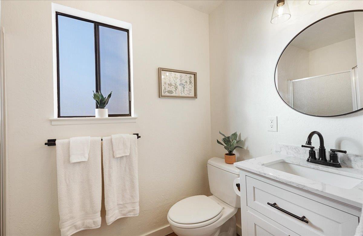 3003 Corte Cabrillo Aptos, CA 95003 - Photo 16 of 33 a bathroom with a toilet a sink and mirror