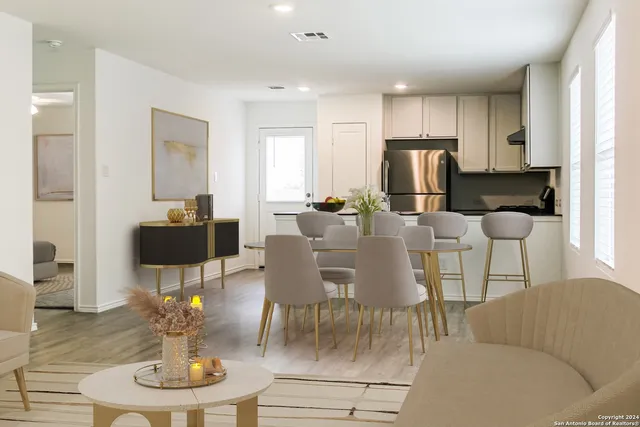 a living room with furniture a dining table and kitchen view