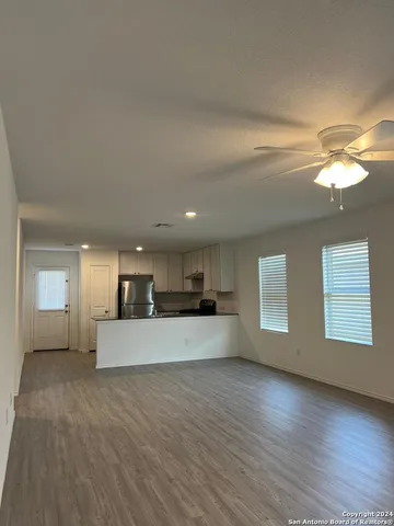 a view of a kitchen with a sink cabinets and wooden floor