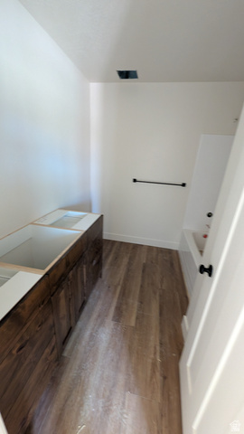26063 North 8800th West Portage, UT 84331 - Photo 9 of 9 Spacious room featuring wood-finish flooring, a long wood-finish vanity base with multiple cabinets, and a white interior door with black hardware
