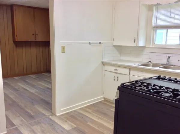 a kitchen with wooden cabinets and a stove top oven