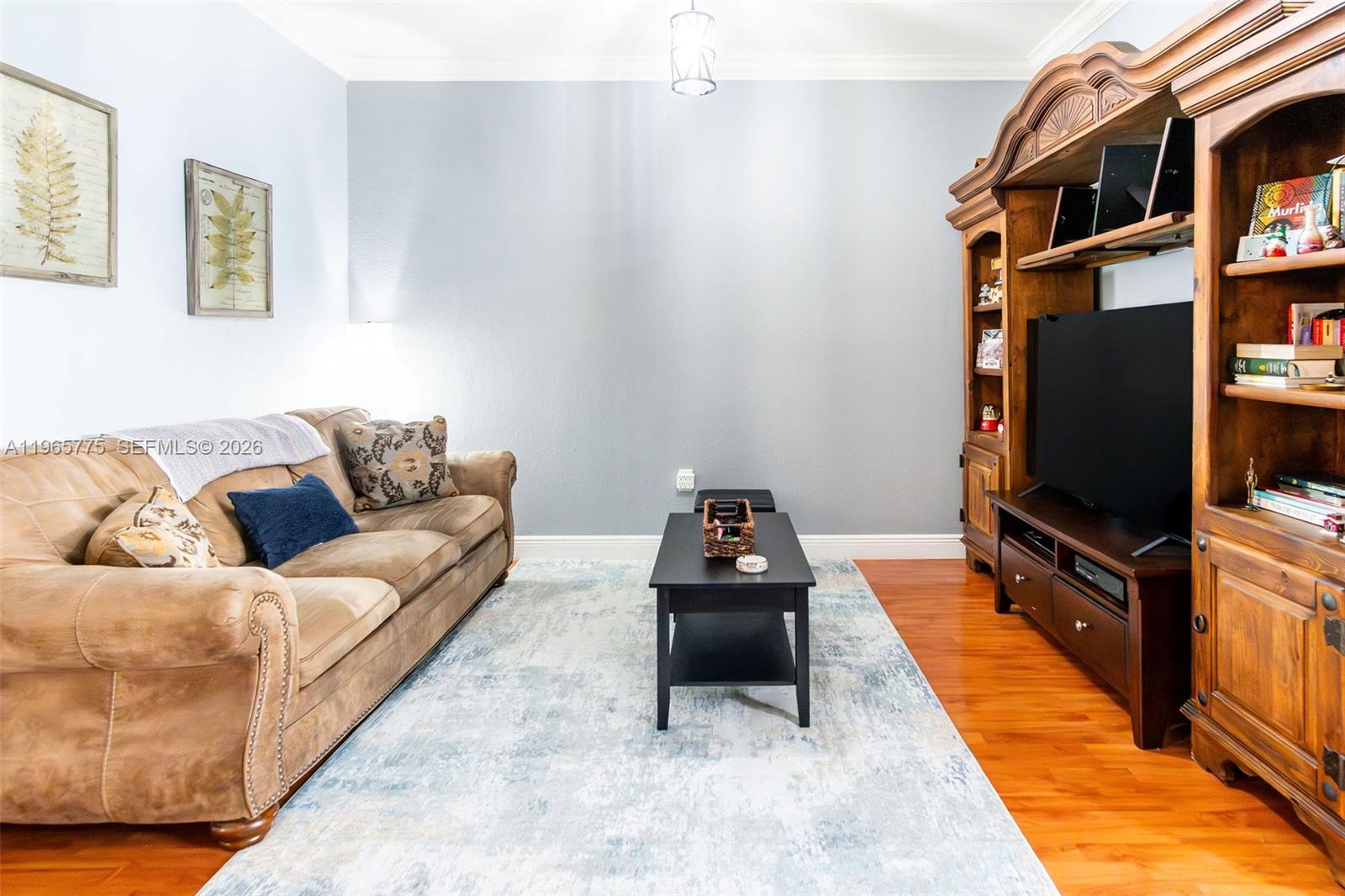 12523 Southwest 121st Way Miami, FL 33186 - Photo 11 of 56 a living room with furniture and a flat screen tv