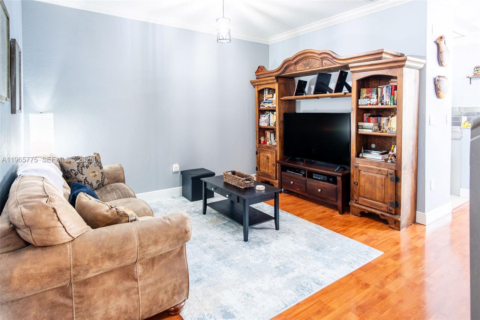 12523 Southwest 121st Way Miami, FL 33186 - Photo 12 of 56 a living room with furniture and a flat screen tv