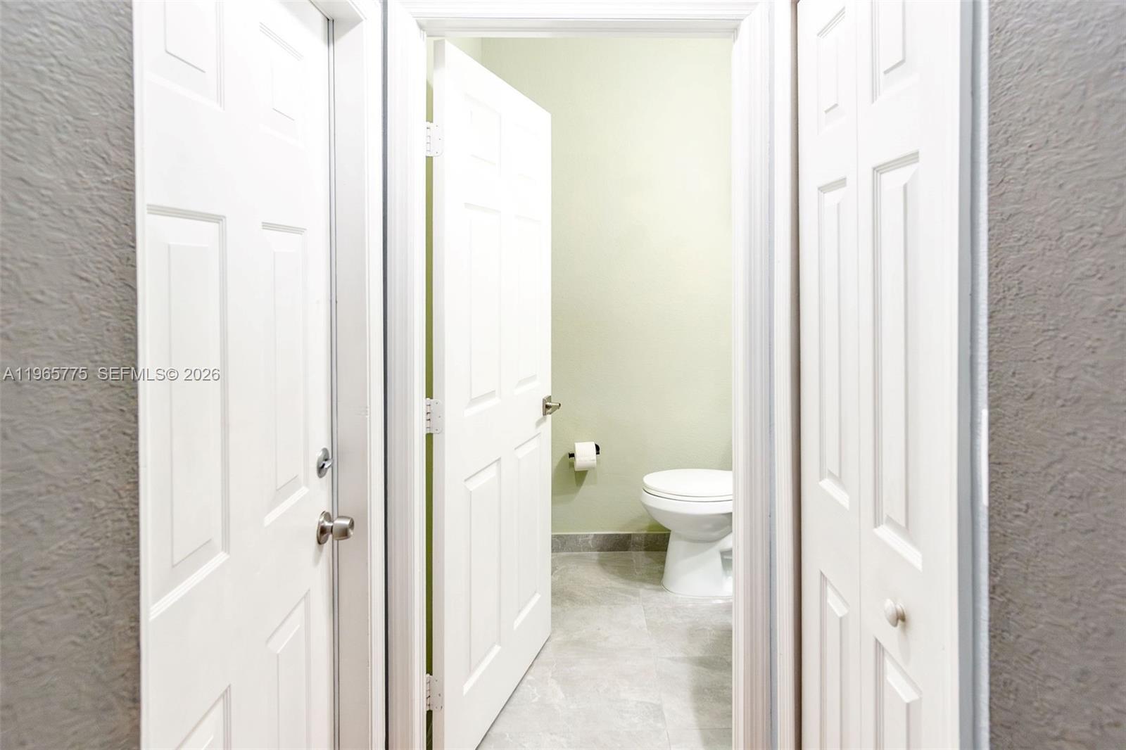 12523 Southwest 121st Way Miami, FL 33186 - Photo 14 of 56 a bathroom with a toilet