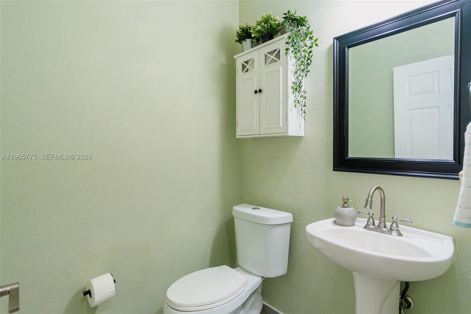 12523 Southwest 121st Way Miami, FL 33186 - Photo 15 of 56 a bathroom with a toilet sink and mirror