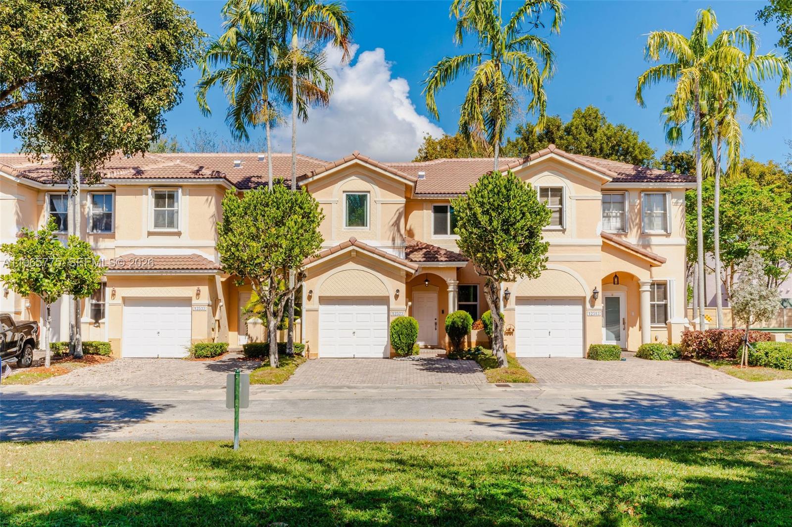 12523 Southwest 121st Way Miami, FL 33186 - Photo 2 of 56 a front view of a house with a yard