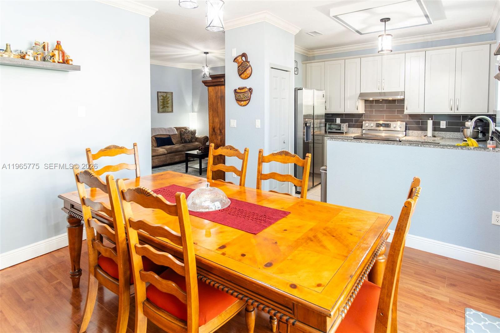 12523 Southwest 121st Way Miami, FL 33186 - Photo 22 of 56 a view of a dining room with furniture and wooden floor