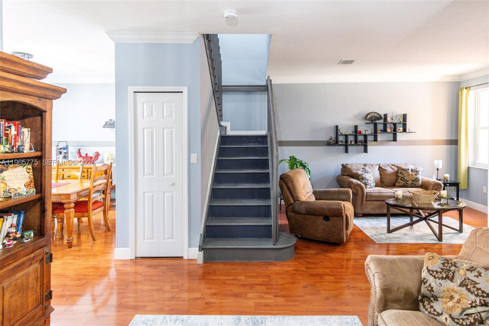 12523 Southwest 121st Way Miami, FL 33186 - Photo 25 of 56 a living room with furniture and stairs