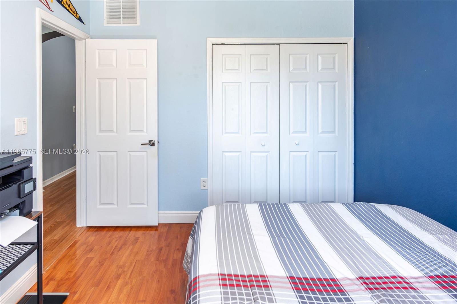 12523 Southwest 121st Way Miami, FL 33186 - Photo 28 of 56 a view of a bedroom with wooden floor and closet