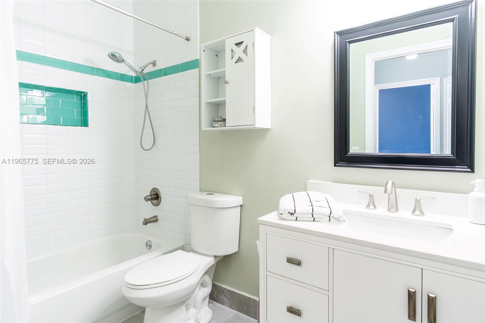 12523 Southwest 121st Way Miami, FL 33186 - Photo 30 of 56 a bathroom with a sink a toilet and shower