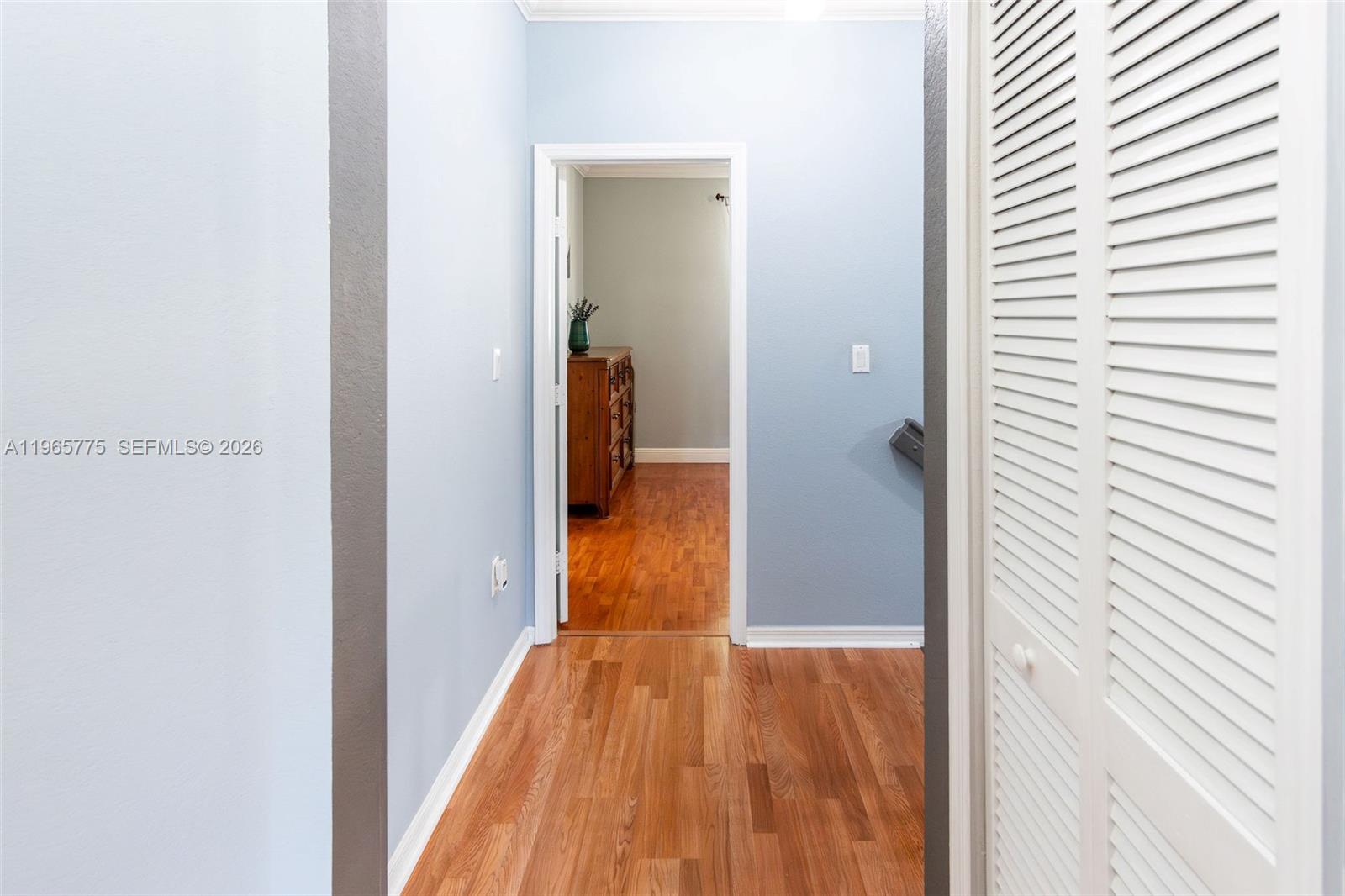 12523 Southwest 121st Way Miami, FL 33186 - Photo 31 of 56 a view of a hallway with wooden floor