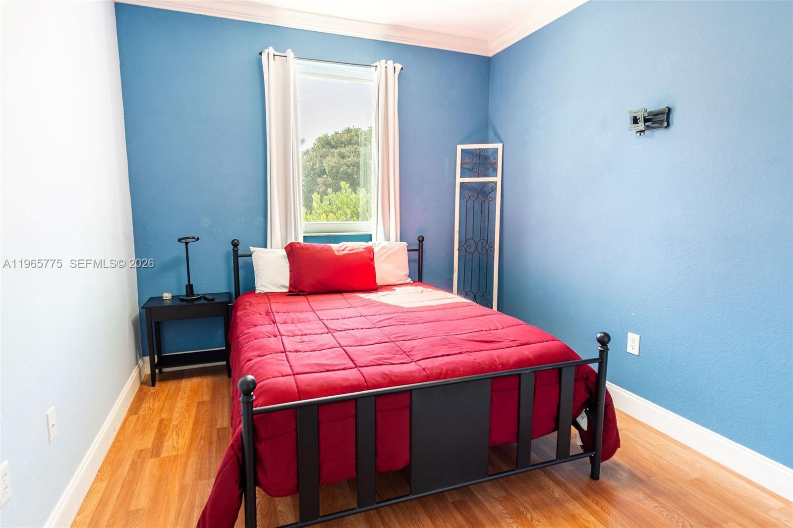 12523 Southwest 121st Way Miami, FL 33186 - Photo 32 of 56 a bedroom with a bed and wooden floor